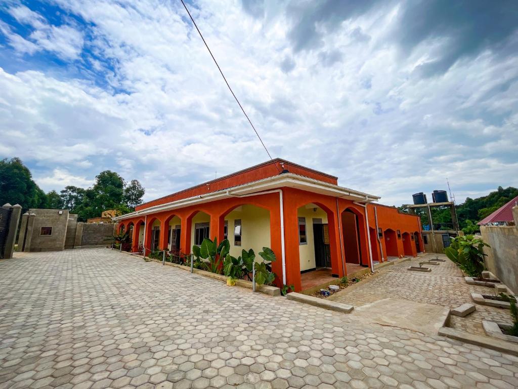 an orange and white building on a street at NB MOTEL-KIHIHI in Kihihi