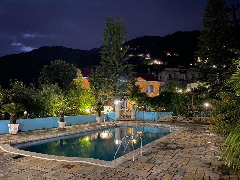 a swimming pool in a yard at night at Initial Cold Lodge in Burhānilkantha