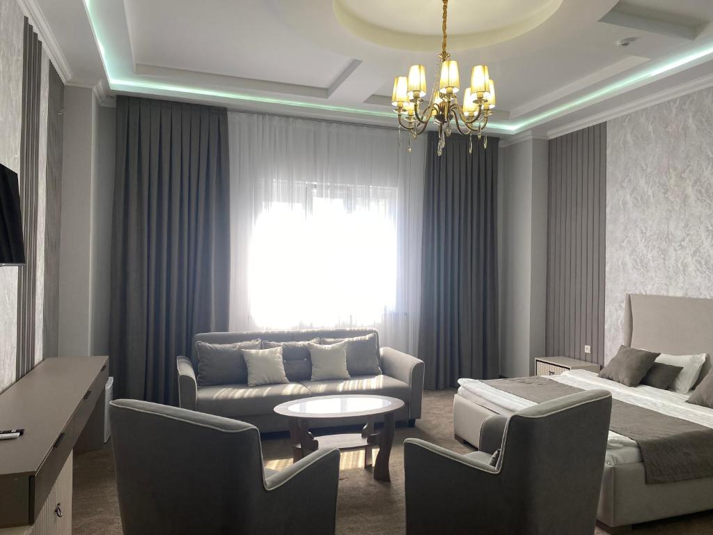 a living room with a couch and a bed at IMPERIAL in Taraz