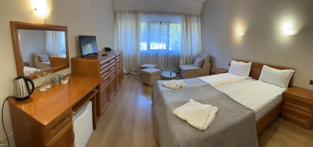 a hotel room with a large bed and a bathroom at Room in BB - Hotel Moura Double Room in Borovets
