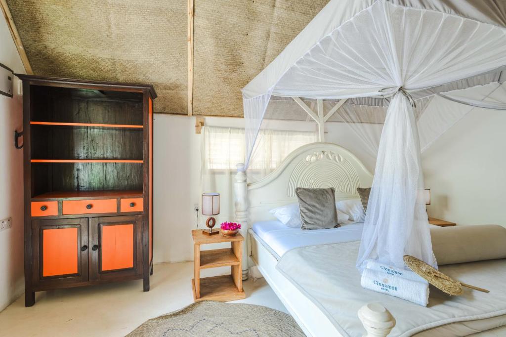Postel nebo postele na pokoji v ubytování Cinnamon Hotel