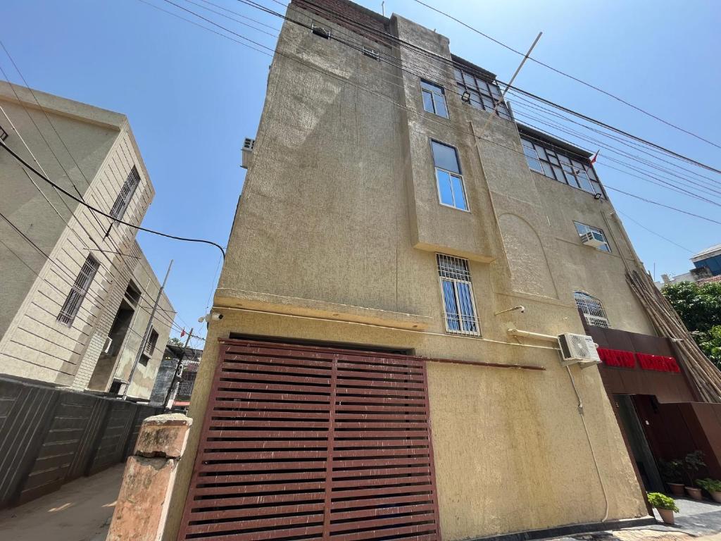 a building with a large garage door on the side of it at Hotel Pratap Heights in Rānchī