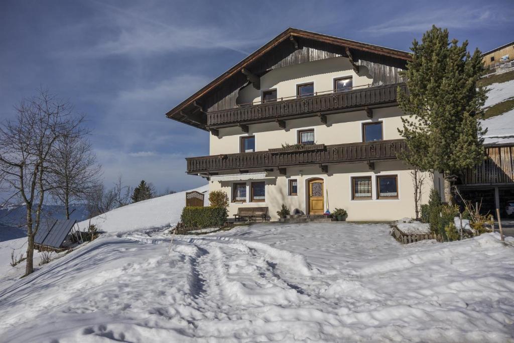 a house in the snow with a driveway at Schwendter-Hof in Westendorf