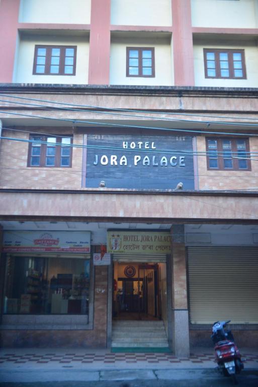 a hotel jora palace with a motorcycle parked in front of it at Hotel Jora Palace in Jorhāt