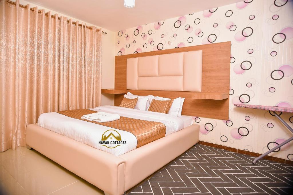 a hotel room with two beds and a tv at Havan Furnished Apartment-Milimani N9 in Nakuru