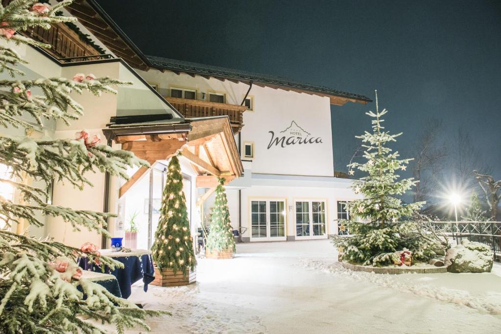 a building with christmas trees in front of it at Hotel Marica in Eggen