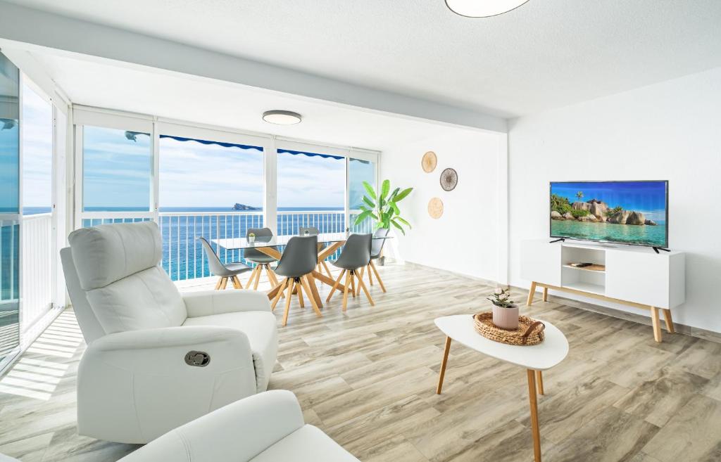 a living room with a white couch and a table at Torre Yago Apartment 15-2 Levante Beach in Benidorm