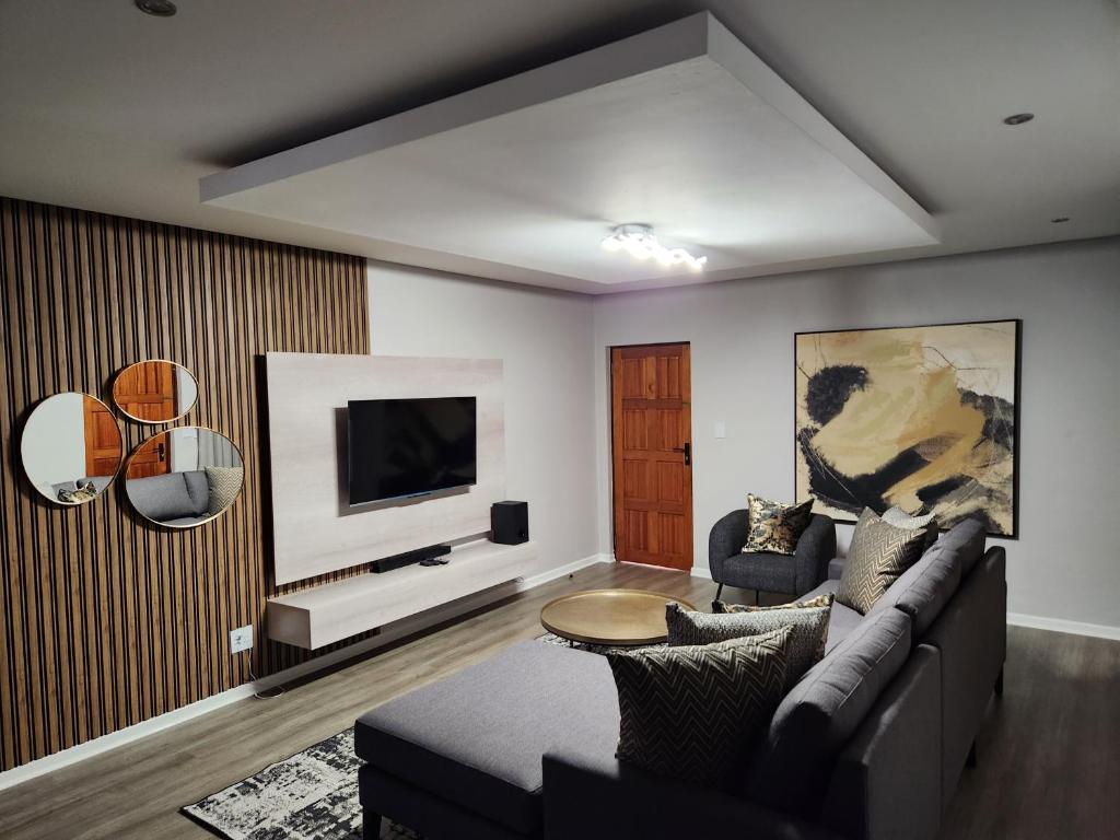 a living room with a couch and a tv at Villa Casa Lifestyle in Nelspruit