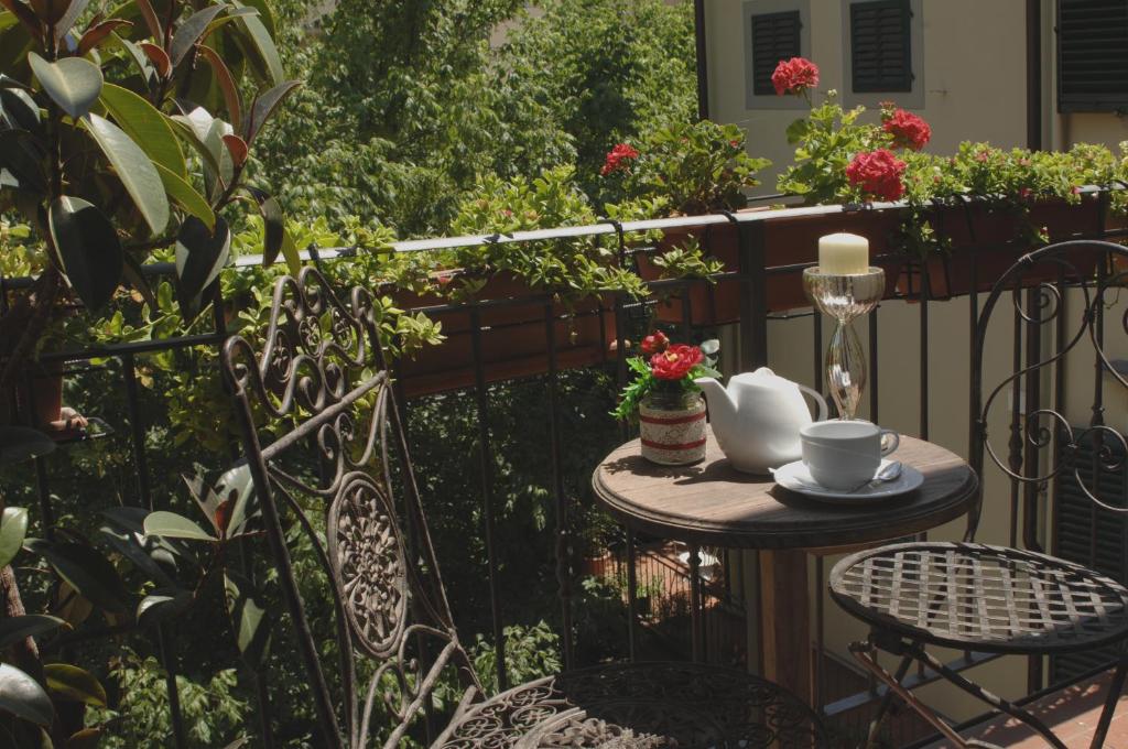 a small table with a cup of coffee on a balcony at Relais Dante e Beatrice in Florence