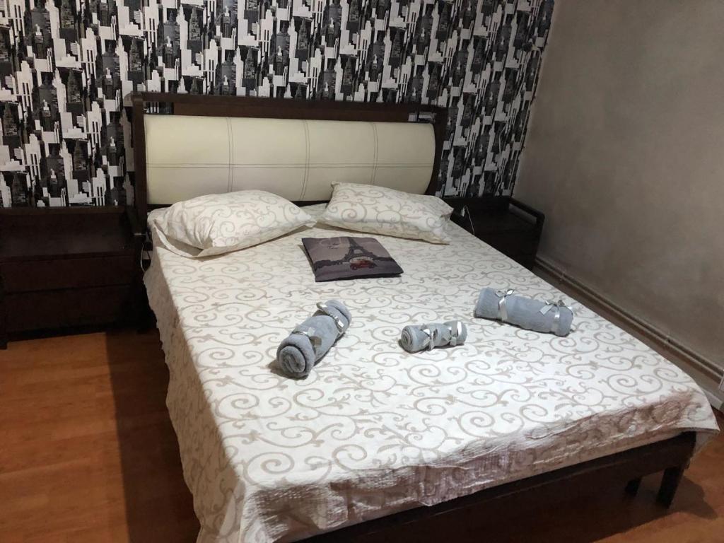 a bed with two shoes and a book on it at Neversea Black Sea in Constanţa