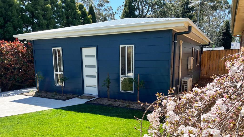 a blue tiny house in a yard at Honey Fig Cottage, Bowral in Bowral