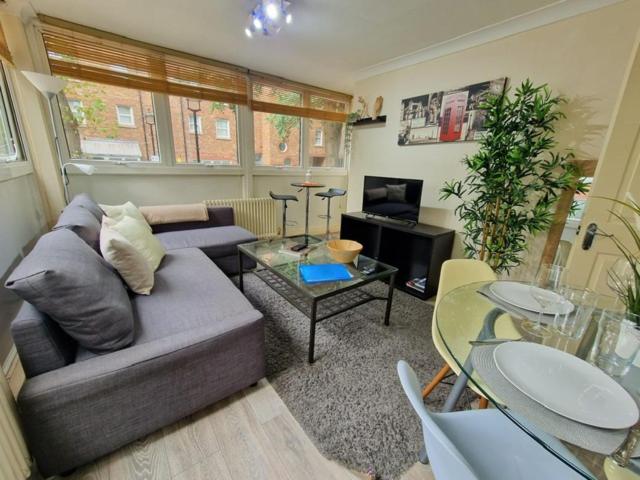 a living room with a couch and a table at 2 Bedroom flat in great location! in London