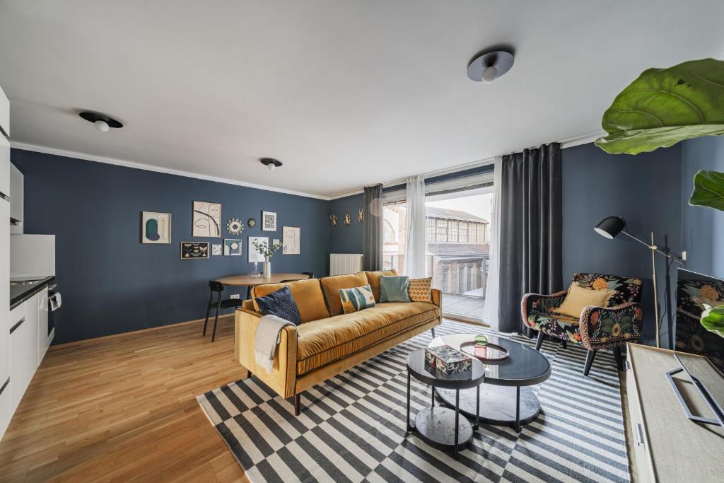 a living room with a couch and a table at Modern Living Apartments Vienna, 15 min to center in Vienna