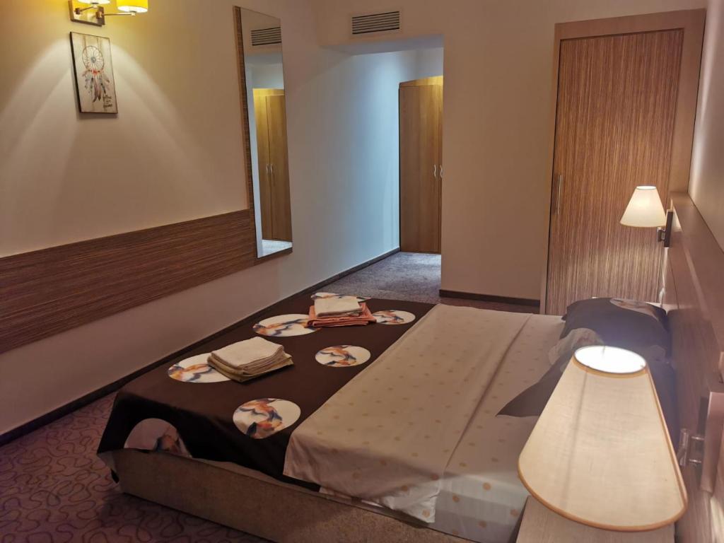 a hotel room with a bed with a mirror at Rin Grand Residence Regim Hotelier in Bucharest