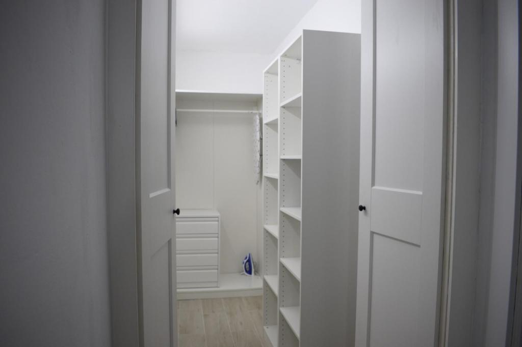 a white closet with white shelves in a room at El Molino in La Aldea de San Nicolas