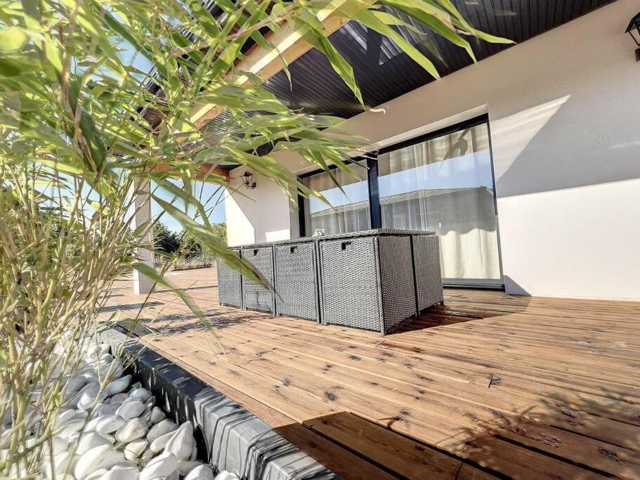 a house with a wooden deck with a tree at Well’Home Bali - Superbe villa au Nord de Toulouse in Mirepoix-sur-Tarn