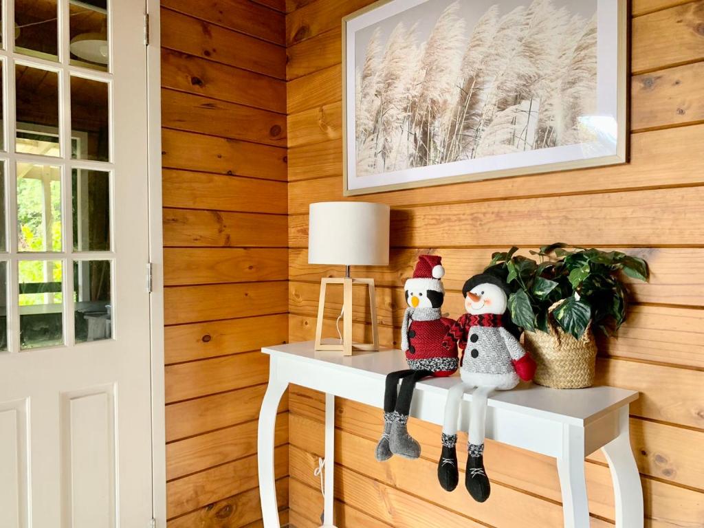 een kamer met een tafel met twee sneeuwpoppen erop bij The whole riverside holiday home 4 Bedrooms in Hamilton