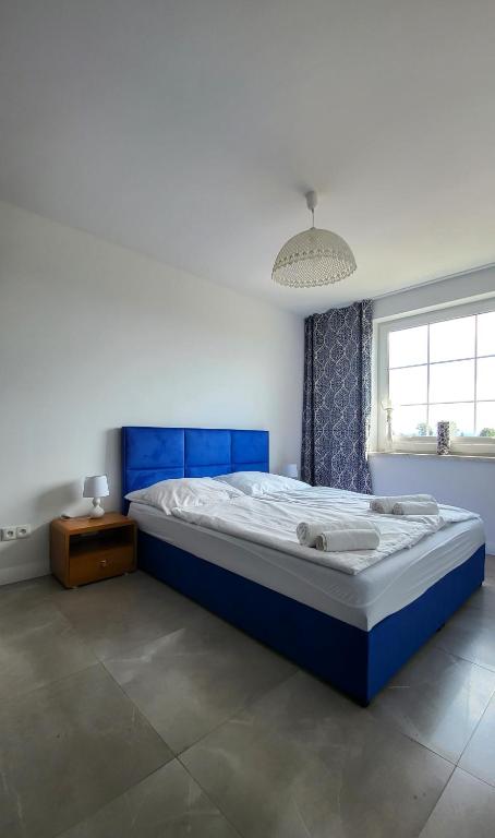 Posteľ alebo postele v izbe v ubytovaní Apartamenty Czerwona Stodoła
