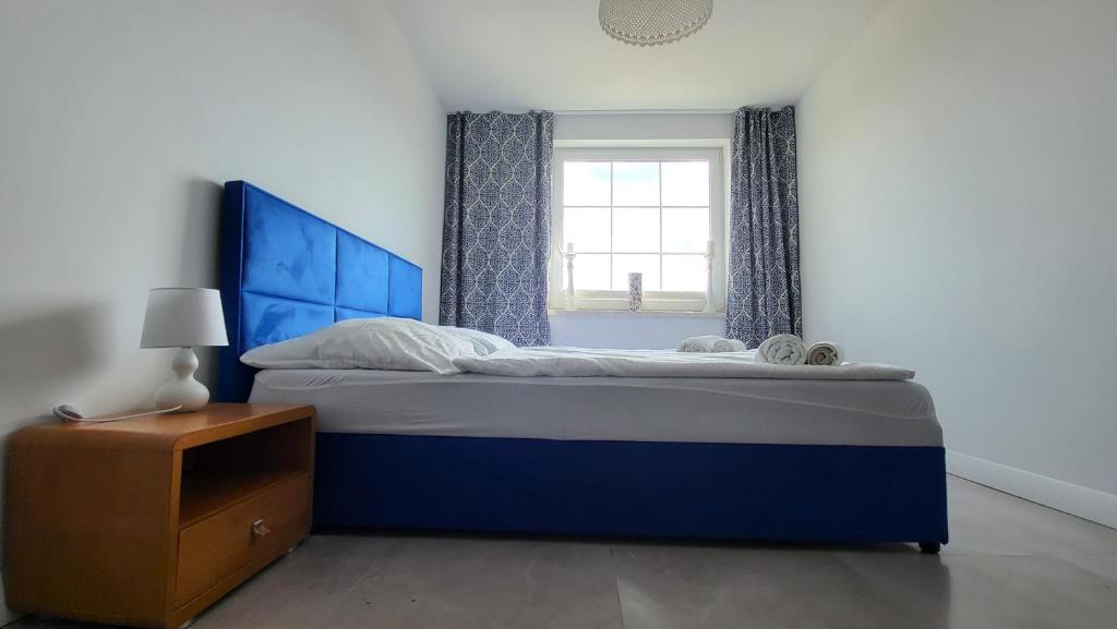Posteľ alebo postele v izbe v ubytovaní Apartamenty Czerwona Stodoła