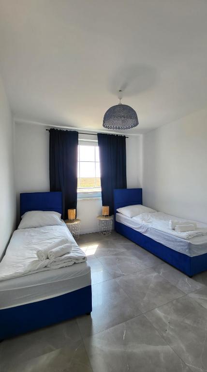 Posteľ alebo postele v izbe v ubytovaní Apartamenty Czerwona Stodoła