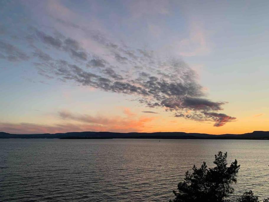 a sunset over a large body of water at Exclusive panorama view of the Oslofjord 