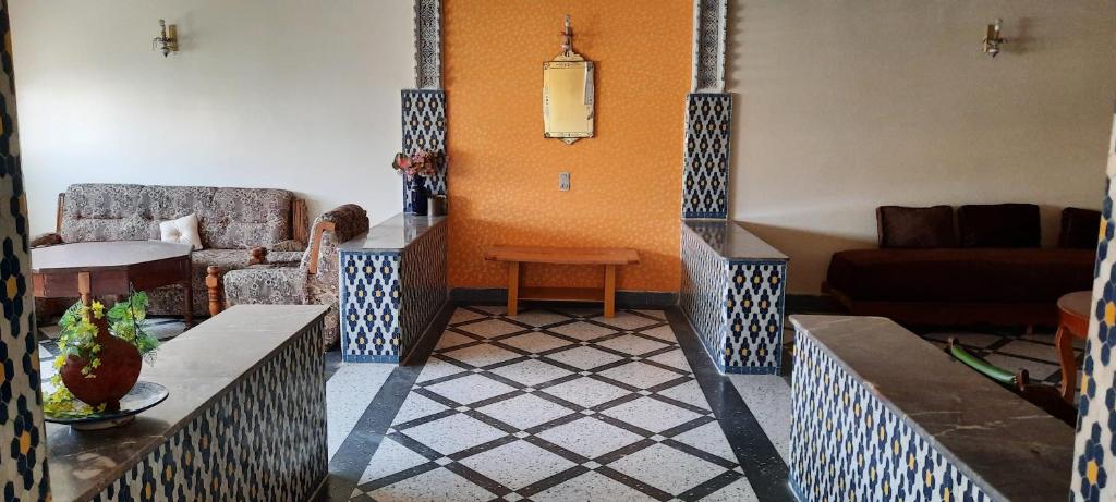 a living room with a couch and a table at Dar bouhlal in Fez