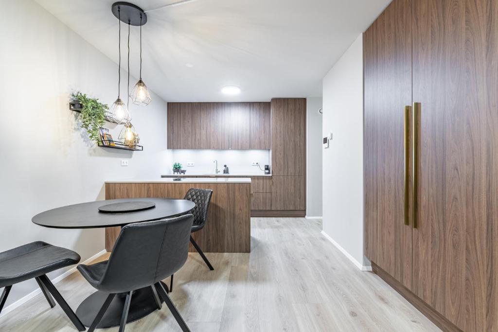 a kitchen and dining room with a table and chairs at Grandinn Luxury apartment in Downtown Reykjavík in Reykjavík