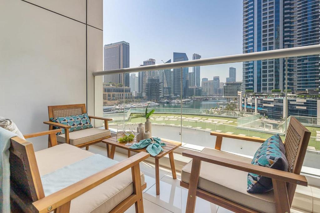 a balcony with chairs and a view of a city at Frank Porter - Continental Tower in Dubai