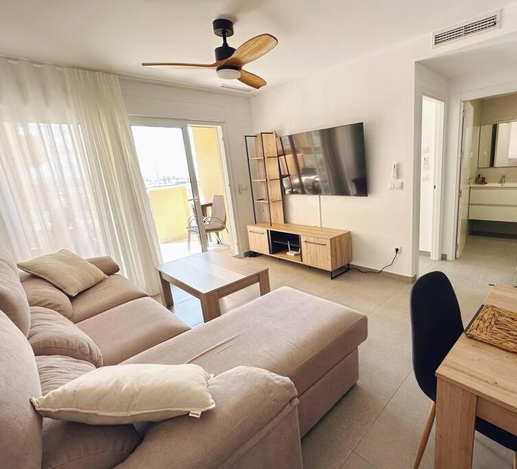 a living room with a couch and a flat screen tv at EMbers La Manga in San Blas