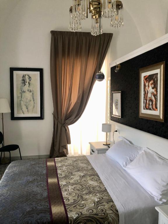 Postel nebo postele na pokoji v ubytování B&B dai Mimmi