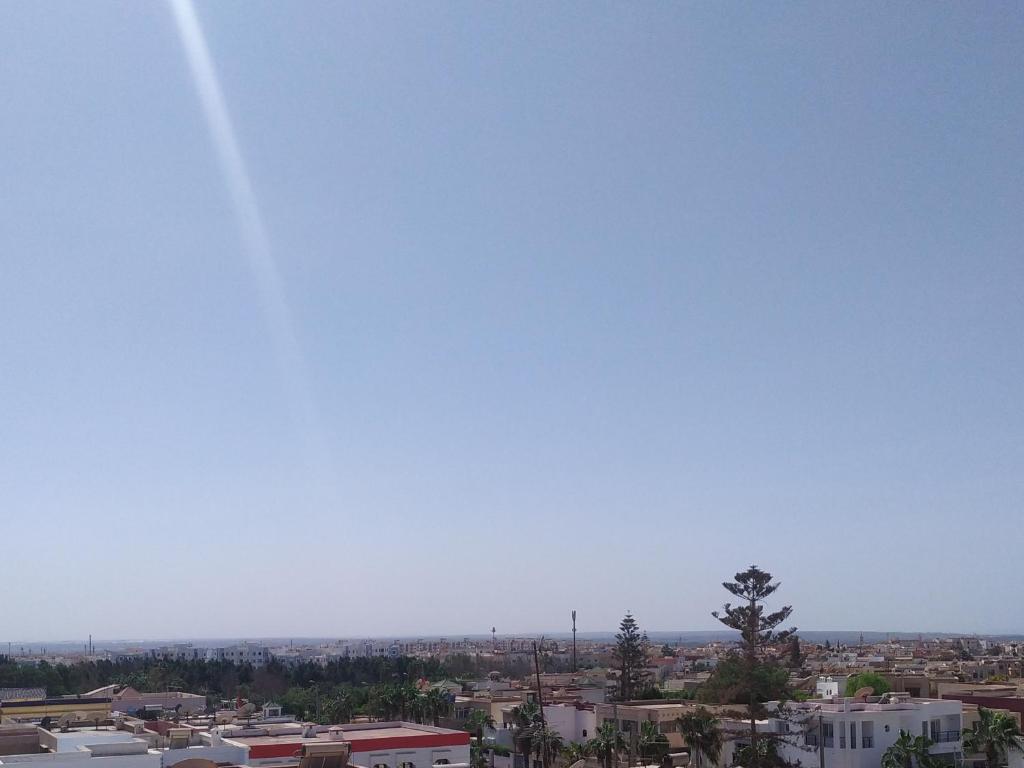 a view of a city with a blue sky at Flat Al farabi in Agadir