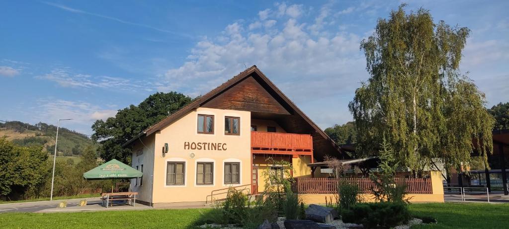 a building with a sign for a house at Penzion Bystřička in Vsetín