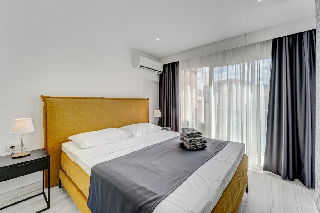 a bedroom with a large bed and a window at BAL Apartments Adults Only in Arona