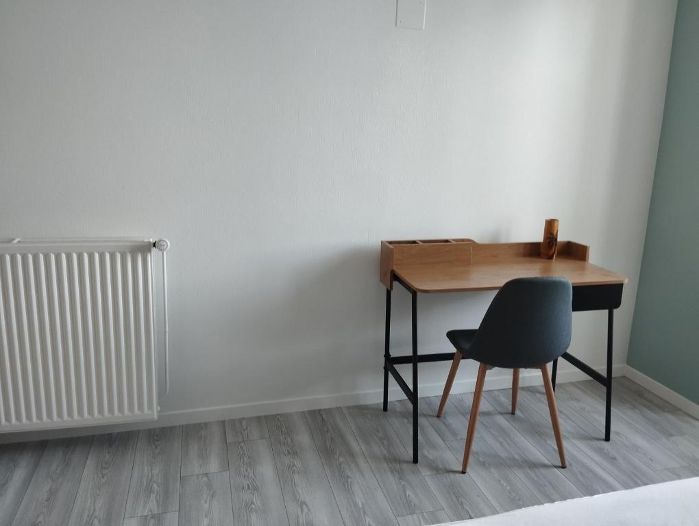a desk and a chair in a room at Maison au calme avec vue étang in Clessé