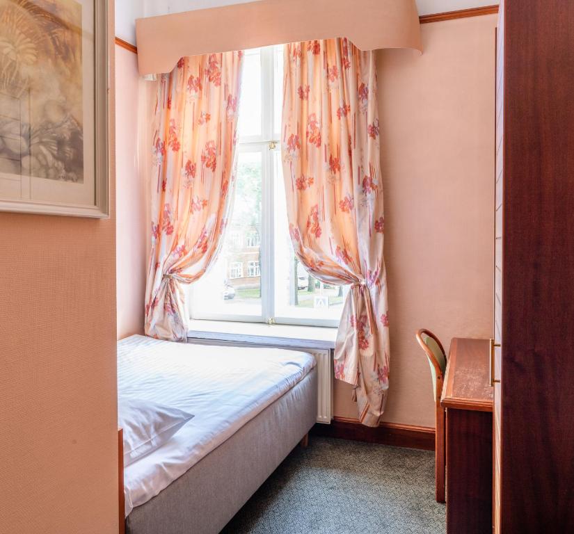 Postel nebo postele na pokoji v ubytování Hotel Victoria