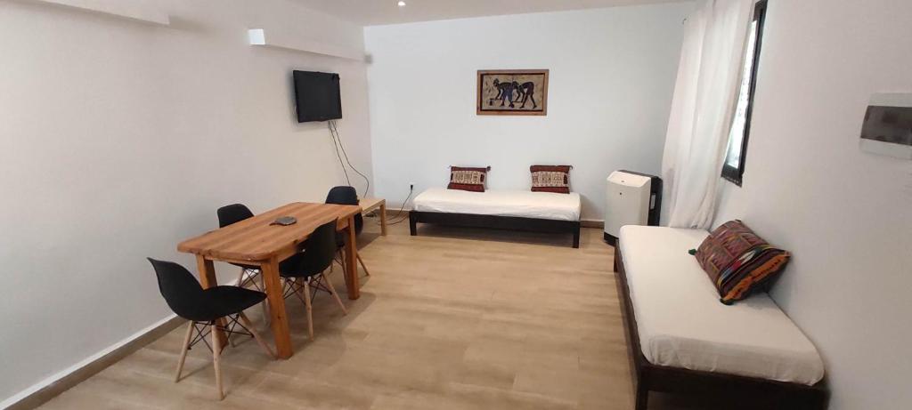 a room with a table and a couch and a bed at F2 duplex plages et promenades in Annaba
