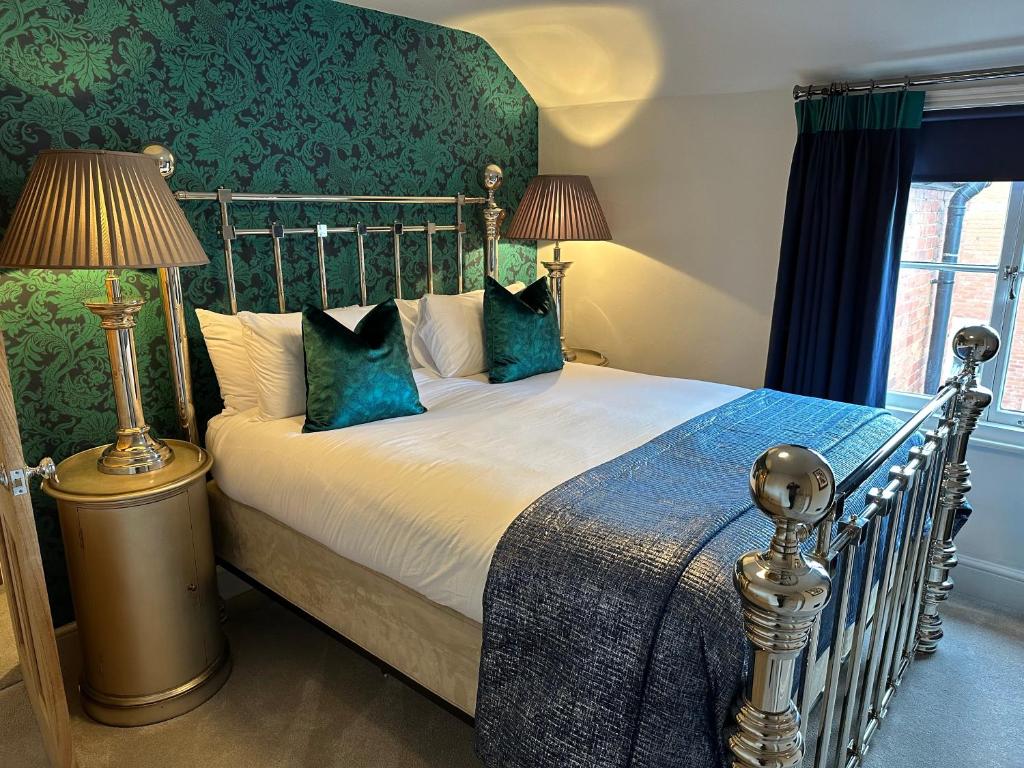 a bedroom with a large bed with blue pillows at Shrewsbury Townhouse - Free Parking in Shrewsbury