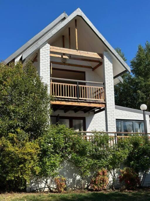 a large house with a balcony on top of it at Clarens Tranquil Mountain Villa in Clarens