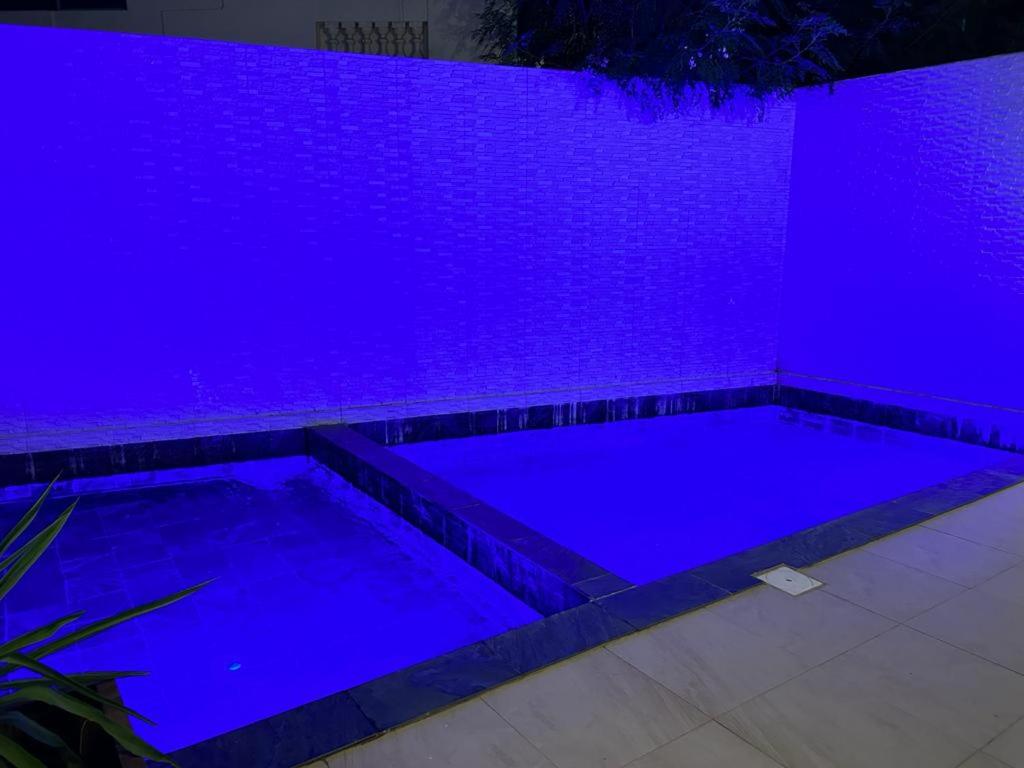a swimming pool lit up with purple lights at Go to the top in Dakar