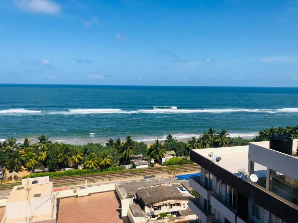 a view of the ocean from the balcony of a building at Green Star City Apartment in Dehiwala