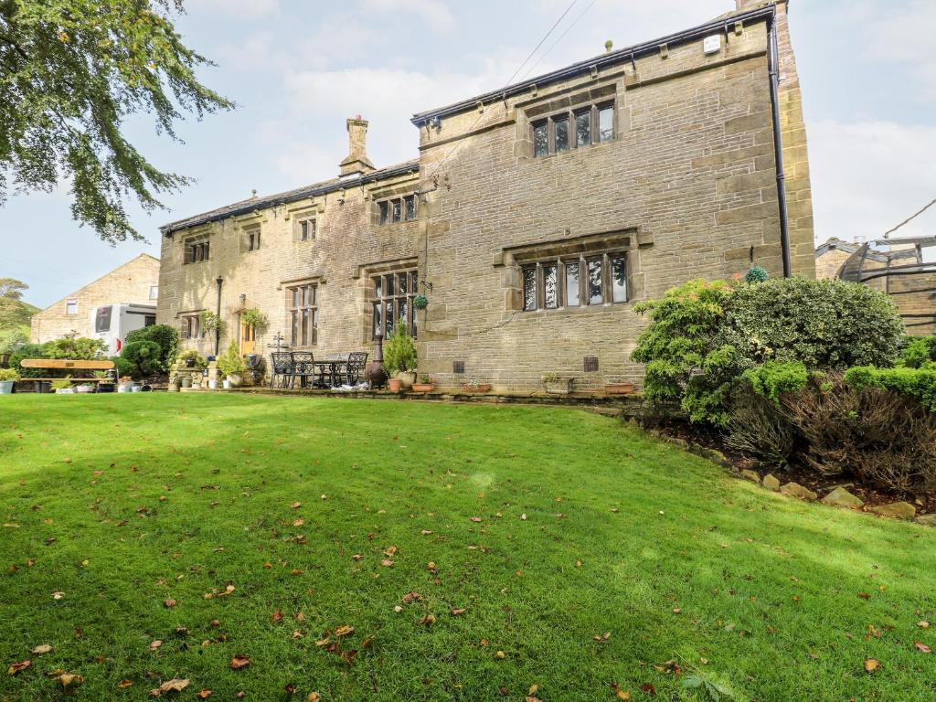 a large brick building with a large yard at Shore Hall in Littleborough