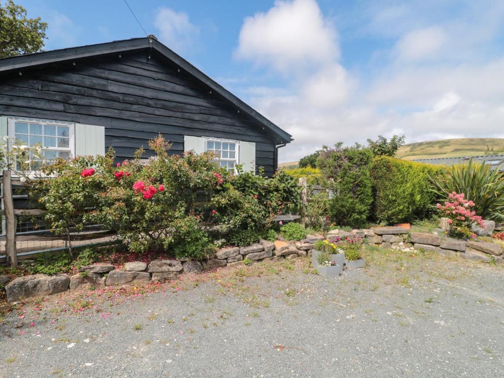 a house with a garden in front of it at Rose Cottage in Swanage