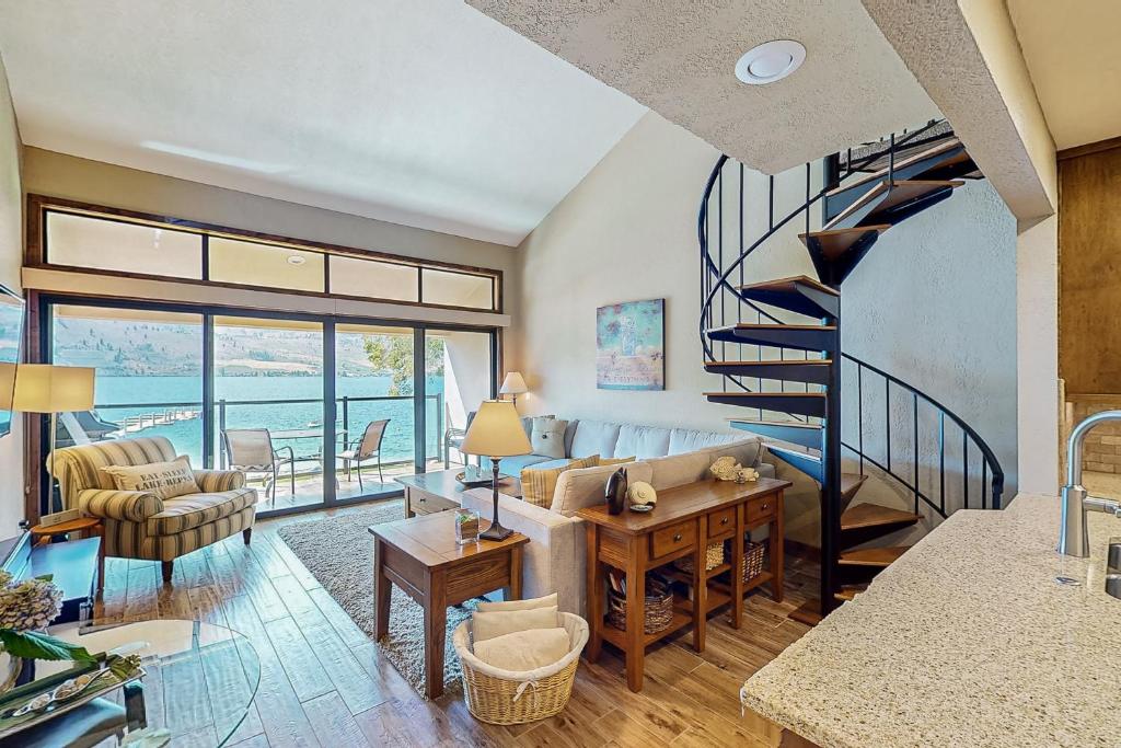 a living room with a spiral staircase in a house at Lake Chelan Shores: Sandy Beach Delight #1-5 in Chelan