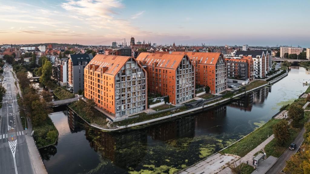 an aerial view of a city with buildings and a river at Apartamenty Sun & Snow Aura in Gdańsk