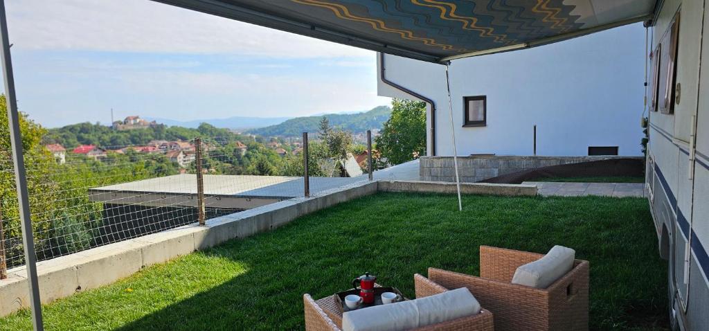 a balcony with chairs and a view of a yard at Campervan romantic getaway in Old Town Brasov in Braşov