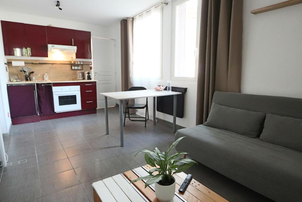 - un salon avec un canapé et une table dans l'établissement Appartement Les Trois Renards-Tassin, à Tassin-la-Demi-Lune