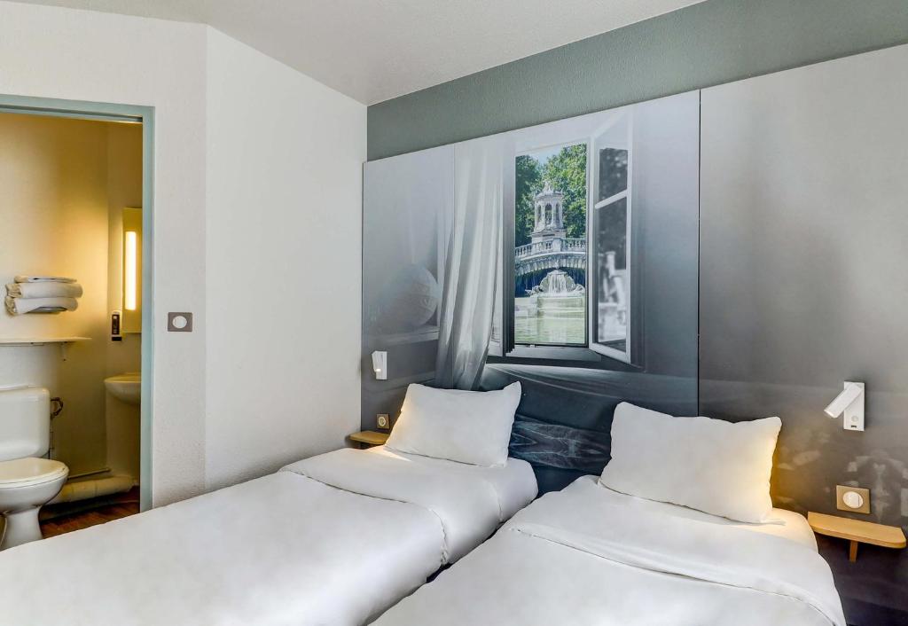 Postel nebo postele na pokoji v ubytování B&B HOTEL Dijon Nord Zénith