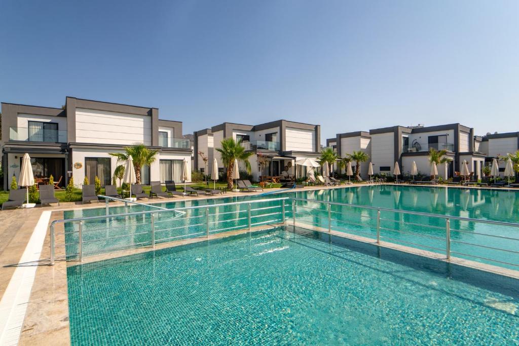 a swimming pool in front of some apartments at Seaside Serenity in Bodrum: Luxury Retreat w View in Turgutreis