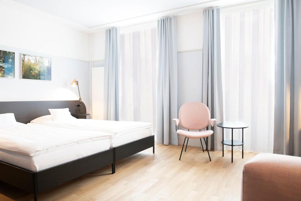 Postel nebo postele na pokoji v ubytování Hotel Schützen Rheinfelden