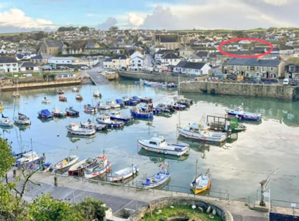 a bunch of boats are docked in a harbor at Chy an Mor in Porthleven